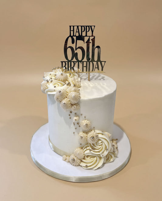 Cream buttercream cake with hand-piped side detailing and edible gold pearl decorations, handmade by Daisy Mud Pie in Brentwood, Essex