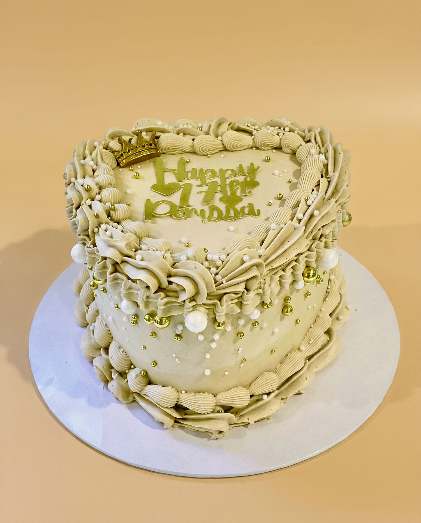 Heart-shaped buttercream cake hand-piped entirely in gold, handmade by Daisy Mud Pie in Brentwood, Essex