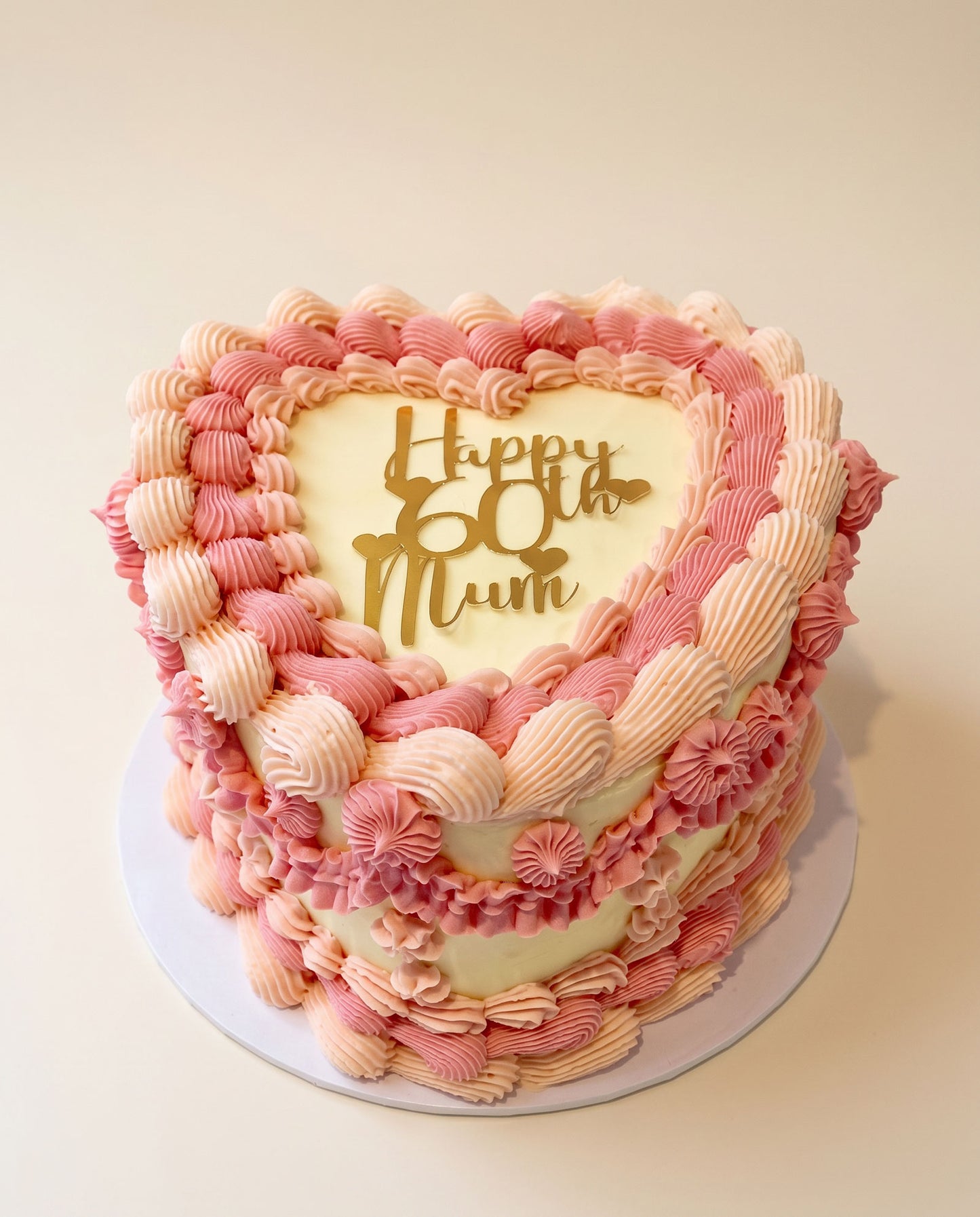 Heart-shaped buttercream cake hand-piped in pale pink, handmade by Daisy Mud Pie in Brentwood, Essex