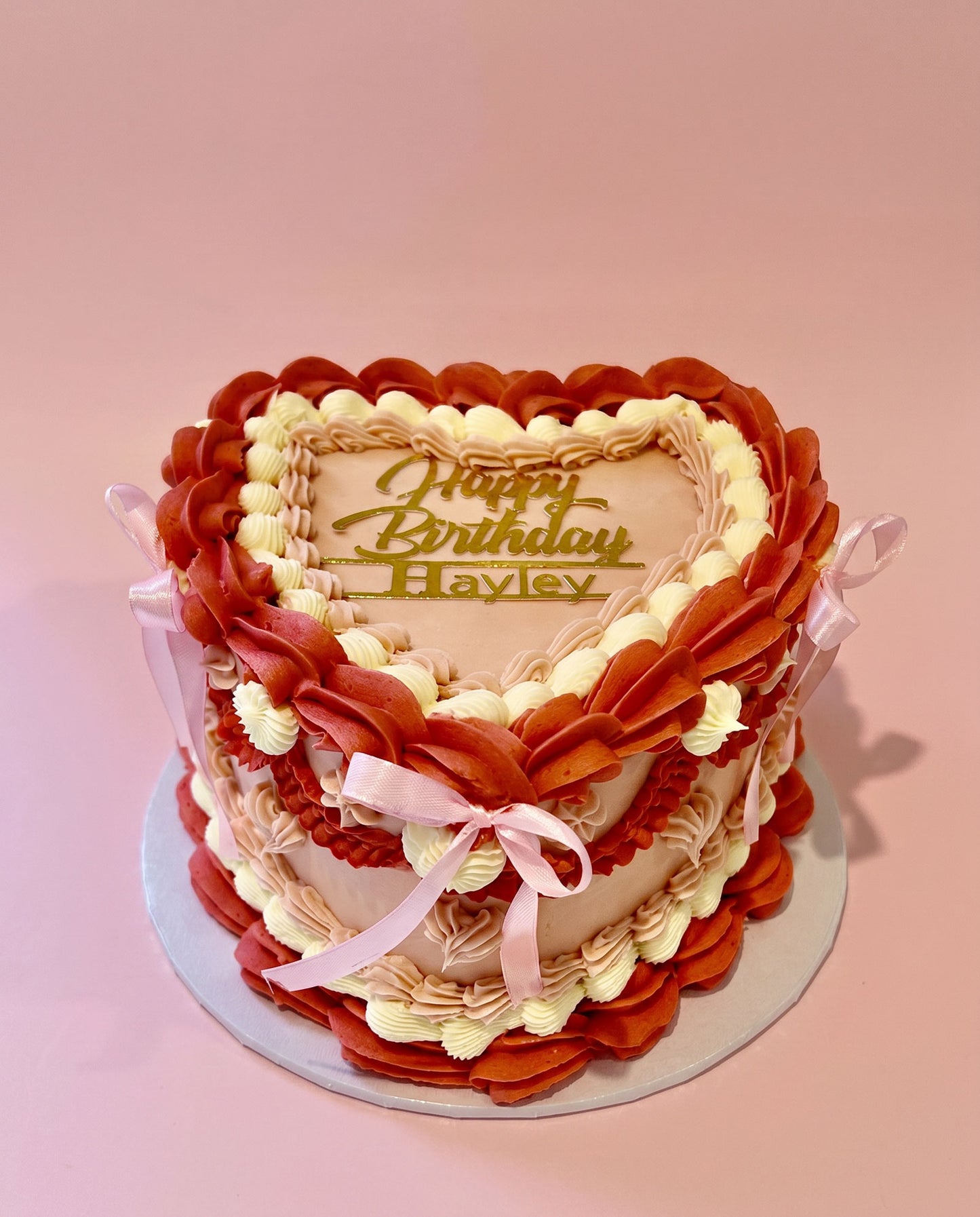 Heart-shaped buttercream cake hand-piped in bold red and white, handmade by Daisy Mud Pie in Brentwood, Essex