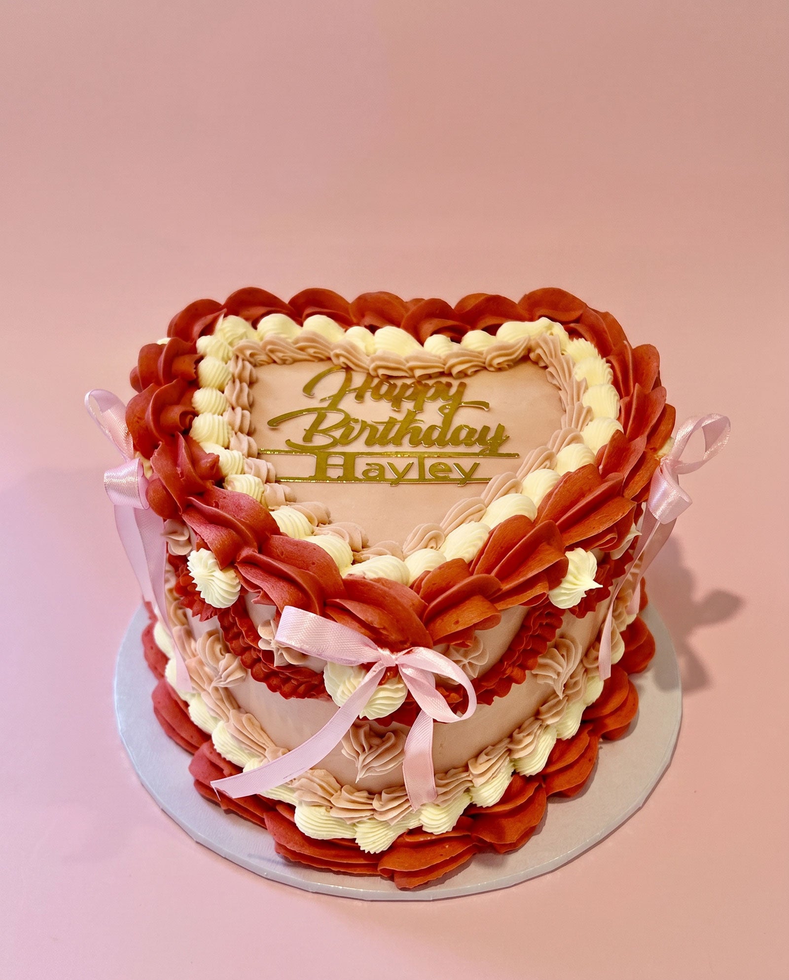 Heart-shaped buttercream cake hand-piped in bold red and white, handmade by Daisy Mud Pie in Brentwood, Essex