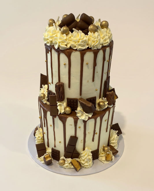 Classic chocolate bar two-tier drip cake with chocolate drip finish and bar toppings, handmade by Daisy Mud Pie in Brentwood, Essex