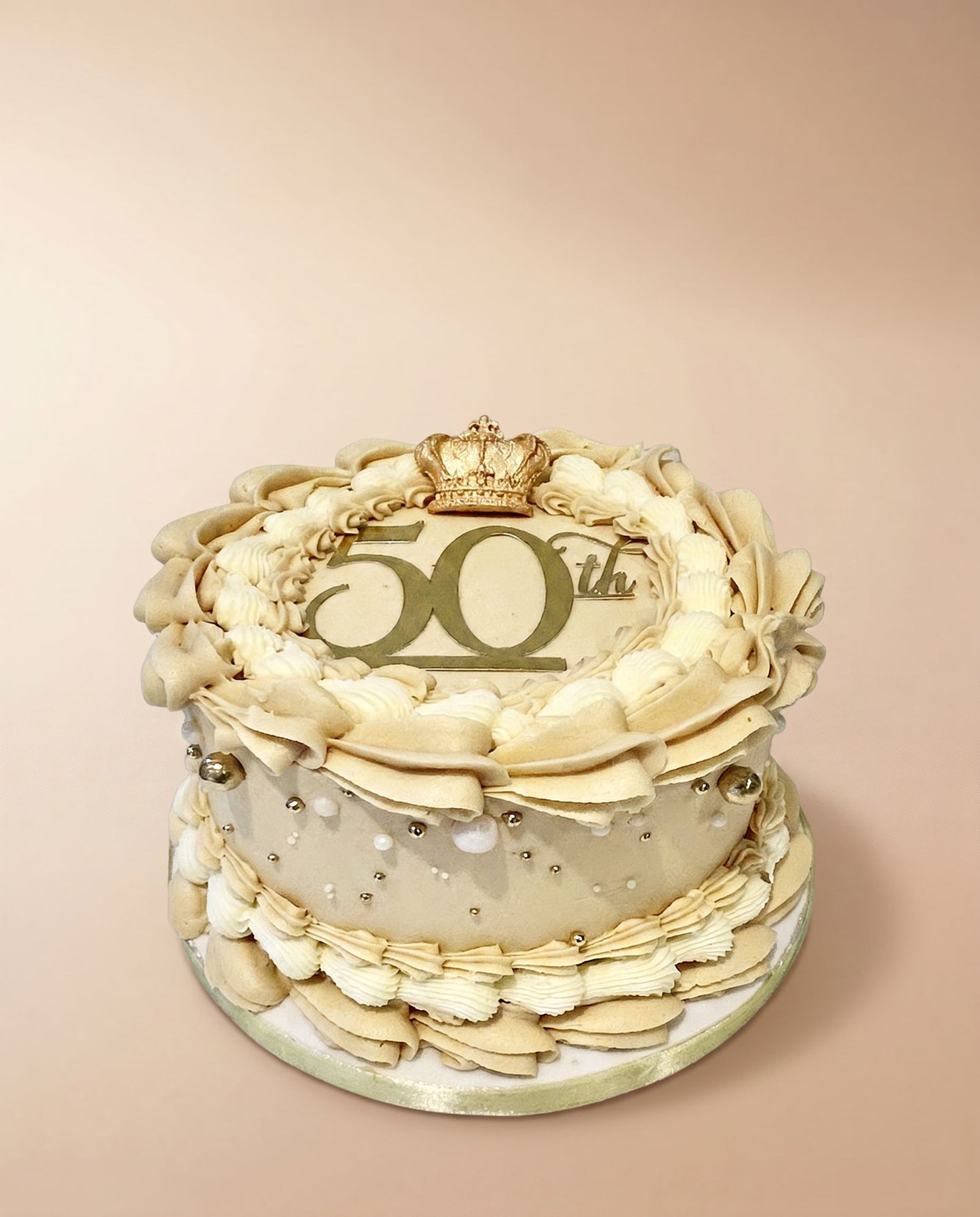 Gold hand-piped buttercream celebration cake with edible pearl decorations and a happy 50th topper, handmade by Daisy Mud Pie in Brentwood, Essex