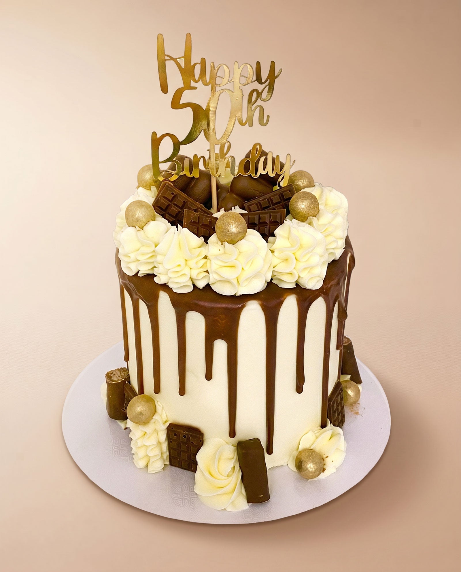 Classic chocolate bar drip cake with a chocolate drip finish and bar toppings, handmade by Daisy Mud Pie in Brentwood, Essex