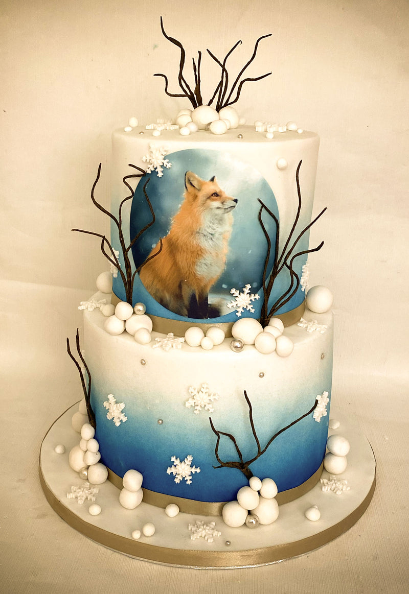 Two-tier custom photo fondant cake with blue ombre finish, sugar pearls, branch details, snowflake decorations and an edible photo print, handmade by Daisy Mud Pie in Brentwood, Essex